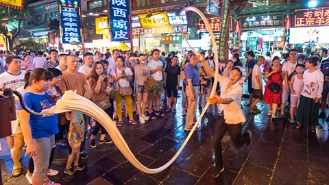 Paul Martin/Alamy As chefs at noodle shops in Xi'an continue to shape the dough by hand, the "biang" sound will remind ersby of the food's curious name (Credit: Paul Martin/Alamy)