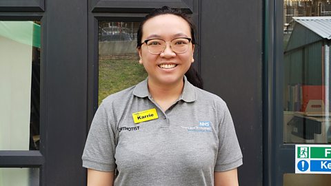 Karrie in her uniform, smiling.