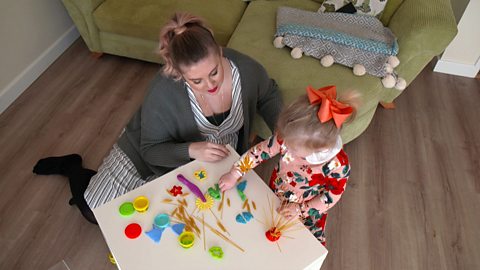 Louise Pentland plays with dry spaghetti and play dough with her daughter, Pearl