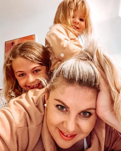 Louise being sat on by her two daughters