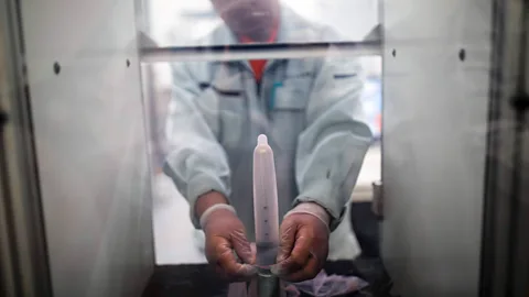 Behrouz Mehri/AFP/Getty Images Researchers are striving for the "perfect condom" in the hope of encouraging more people to use them (Credit: Behrouz Mehri/AFP/Getty Images)