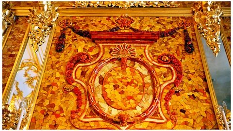 Ivan Vdovin/Alamy Like the original, the recreated Amber Room features amber mounted on gold-leaf walls (Credit: Ivan Vdovin/Alamy)