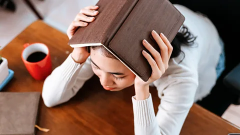 Alamy Anxious woman at her desk