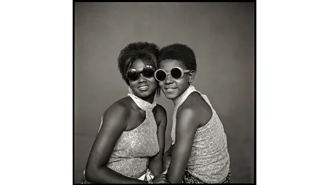 Abdourahmane Sakaly/ Courtesy of The McKinley Collection/The African Lookbook Two 'Ye-Ye' girls in sunglasses, 1965, Mali (Credit: Abdourahmane Sakaly/ Courtesy of The McKinley Collection/The African Lookbook)