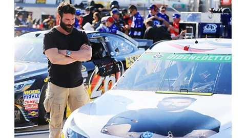 Daniel Shirey/Getty Images Dan Bilzerian looks at a branded racing car bearing his image in Richmond, Virginia (Credit: Daniel Shirey/Getty Images)