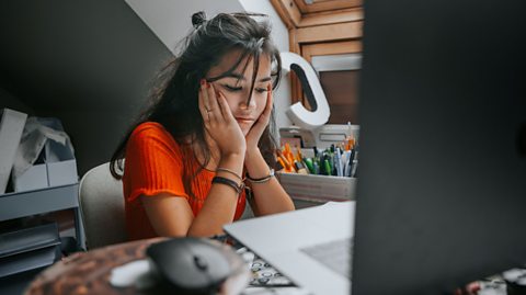 Girl stressed in front of laptop