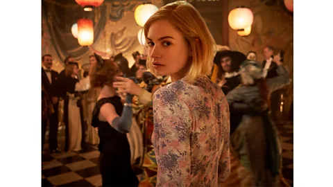 Kerry Brown/ Netflix In Daphne du Maurier's Rebecca, the protagonist wears an ill-advised dress to a party – with disastrous consequences (Credit: Kerry Brown/ Netflix)