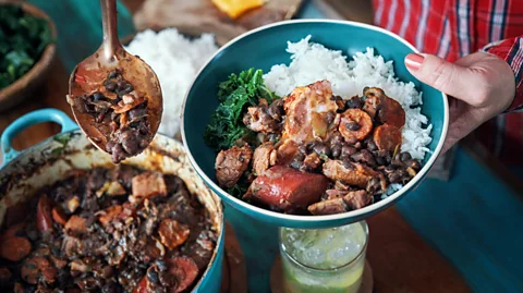 GMVozd/Getty Images Feijoada is a beloved black bean and pork stew that’s known as the most Brazilian of all dishes (Credit: GMVozd/Getty Images)