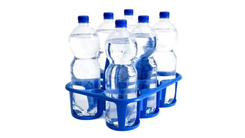 Six bottles of water in a crate