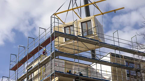 Getty Images Modular construction, as well as using greener materials, is helping to reduce the emissions of construction beyond its machinery (Credit: Getty Images)