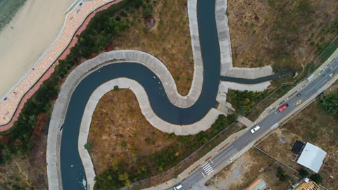 Guillermo Salgado/Getty Images From the air, it looks like the bend of a river, but it is a concrete canal near the coast of Chile to mitigate tsunamis (Credit: Guillermo Salgado/Getty Images)