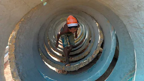 Munir Uz Zaman/Getty Images A child walks inside sewage concrete rings at Jamtola refugee camp in Ukhia, Bangladesh (Credit: Munir Uz Zaman/Getty Images)