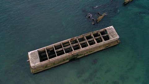 Damien Meyer/Getty Images The ocean laps against the temporary Mulberry harbour, placed on the French coast during WWII to allow rapid offloading of cargo (Credit: Damien Meyer/Getty Images)