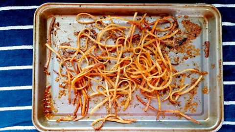 Cooked, seasoned and baked linguine on baking tray