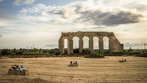 Stefano Castellani People relaxing near the Aqua Claudia in Rome's Park of the Aqueducts