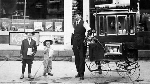 Black and white photo of a popcorn cart