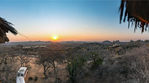 iStock/Getty Images Colourful sunrise over the hills and savanna in Matobo Hills National Park