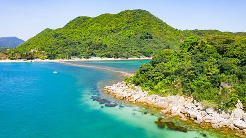 The South China coastline, with blue sea and green hills