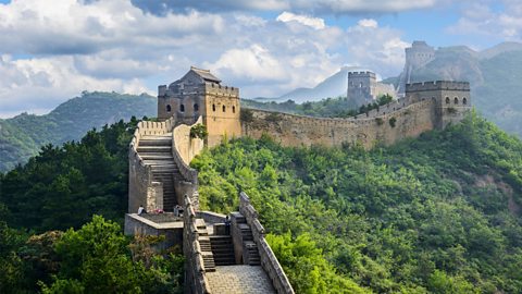 The Great Wall of China in North China. The area is green and cool.