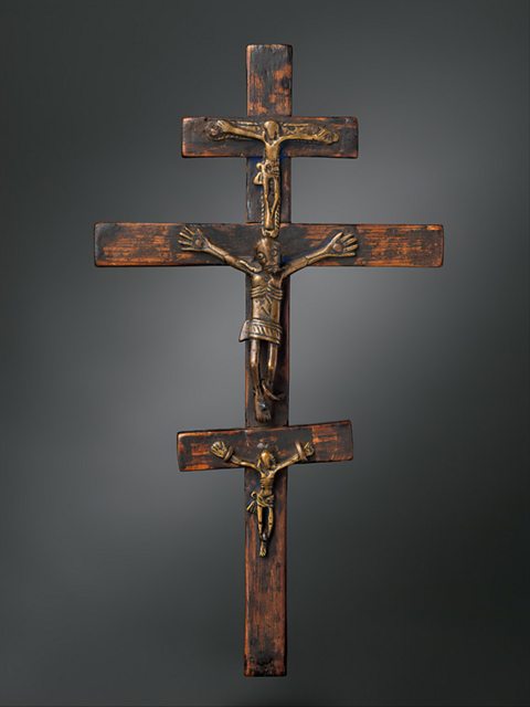 Three adjoining Crucifixes, all stacked on top of each other, made from wood.