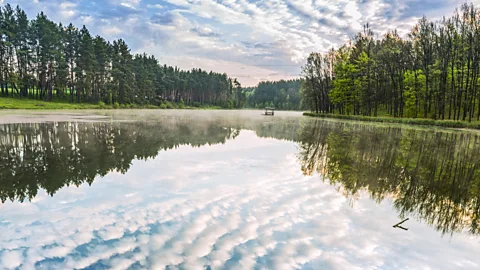 iStock/Getty Images Clouds reflected on water in a peaceful natural setting outside Kyiv, Ukraine