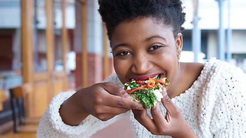 Woman eating vegetable pizza