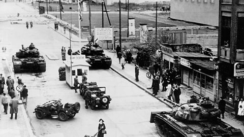 US and Soviet tanks face one another at Checkpoint Charlie, just 75 metres apart.