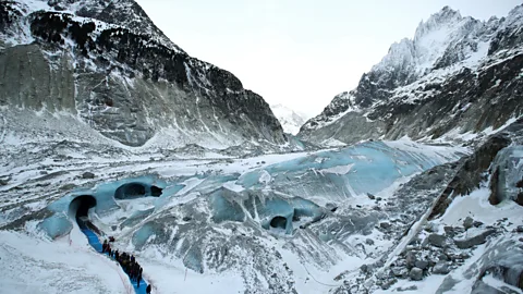 Denis Balibouse/AFP/Getty Images Ice caves carved in the glaciers on Mont Blanc by meltwater are large enough to walk through (Credit: Denis Balibouse/AFP/Getty Images)