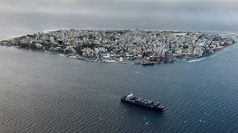 An aerial view of a small island covered with tall buildings