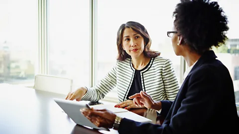 Getty Woman asking her boss for hybrid