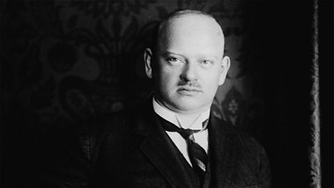 A portrait of Gustav Stresemann, who is standing with his hand in his pocket. 