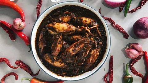Orang Laut Singapore Firdaus Sani serves up traditional dishes like sotong hitam (squid in squid ink) in his food delivery business (Credit: Orang Laut Singapore)