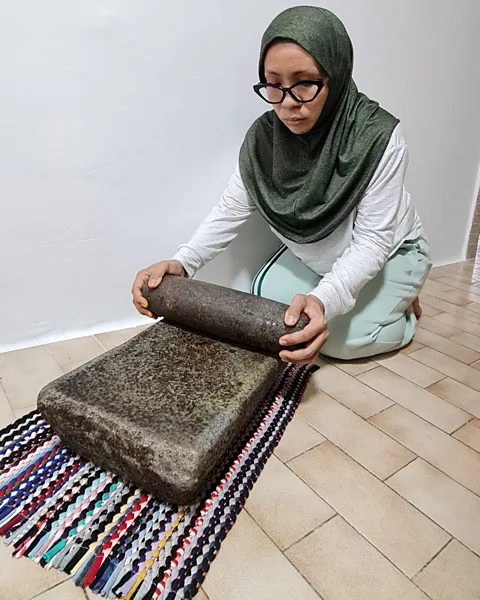 Asnida Daud Asnida Daud's late grandmother's batu giling (mealing stone) is now a prized family heirloom (Credit: Asnida Daud)