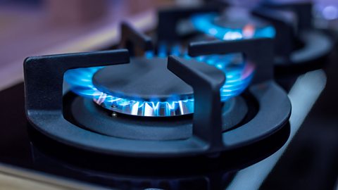 A gas hob with the flame lit.