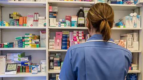 Alamy/ Paul Slater A pharmacist collecting medication from a shelf (Credit: Alamy/ Paul Slater)