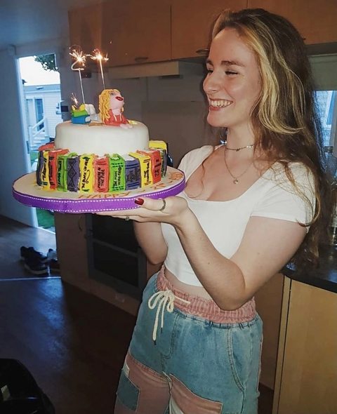 Abby smiling at a book themed birthday cake