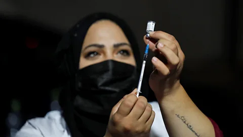 Getty Images An Israeli health worker preparing to ister a booster shot (Credit: Getty Images)