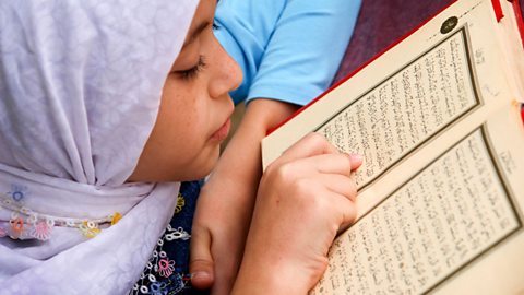 Focus image: a child reading the Qur’an