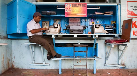 Alamy A typist typing on a typewriter in Mumbai, India (Credit: Alamy)