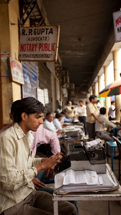 Alamy There are still a large number of court typists in India, who sit outside legal offices and type up case notes on their typewriters (Credit: Alamy)