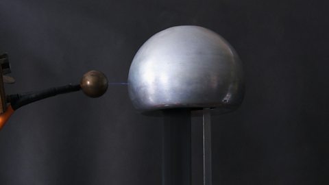 A spark between a earthed conductor and a charged dome of a Van de Graaf generator