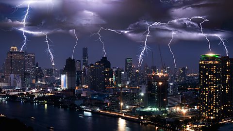 Lightning above tall buildings of a city