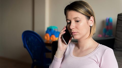 woman on the phone looking worried