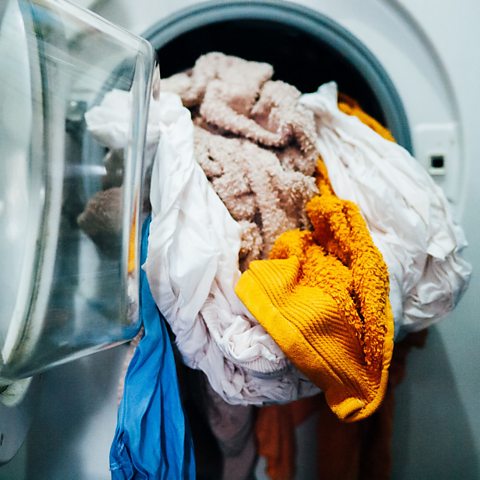 Washing machine being unloaded