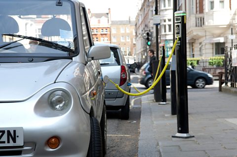 Electric cars being charged up in a UK street.