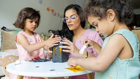 A mother making Diwali decorations with her two daughters 