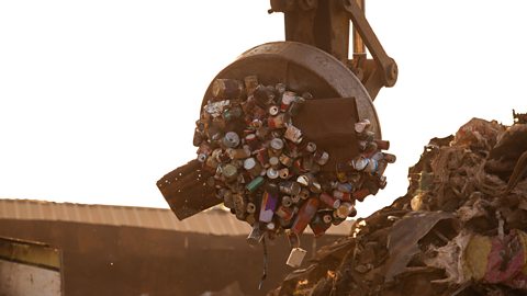 A crane picking up disposed materials