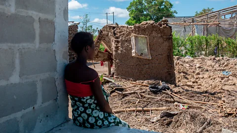 Getty Images A woman observes the ruins of her house destroyed by cyclone Eloise in the Chinamaconde community of northern Mozambique (Credit: Getty Images)