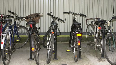 a row of bicycles in a bike rack