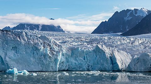 A huge glacier on the island of Spitsbergen, with the ocean in the foreground 